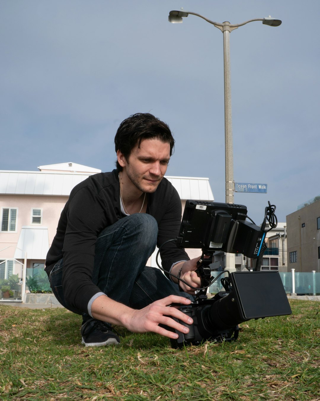 Smiling camera operator holding a professional video camera
